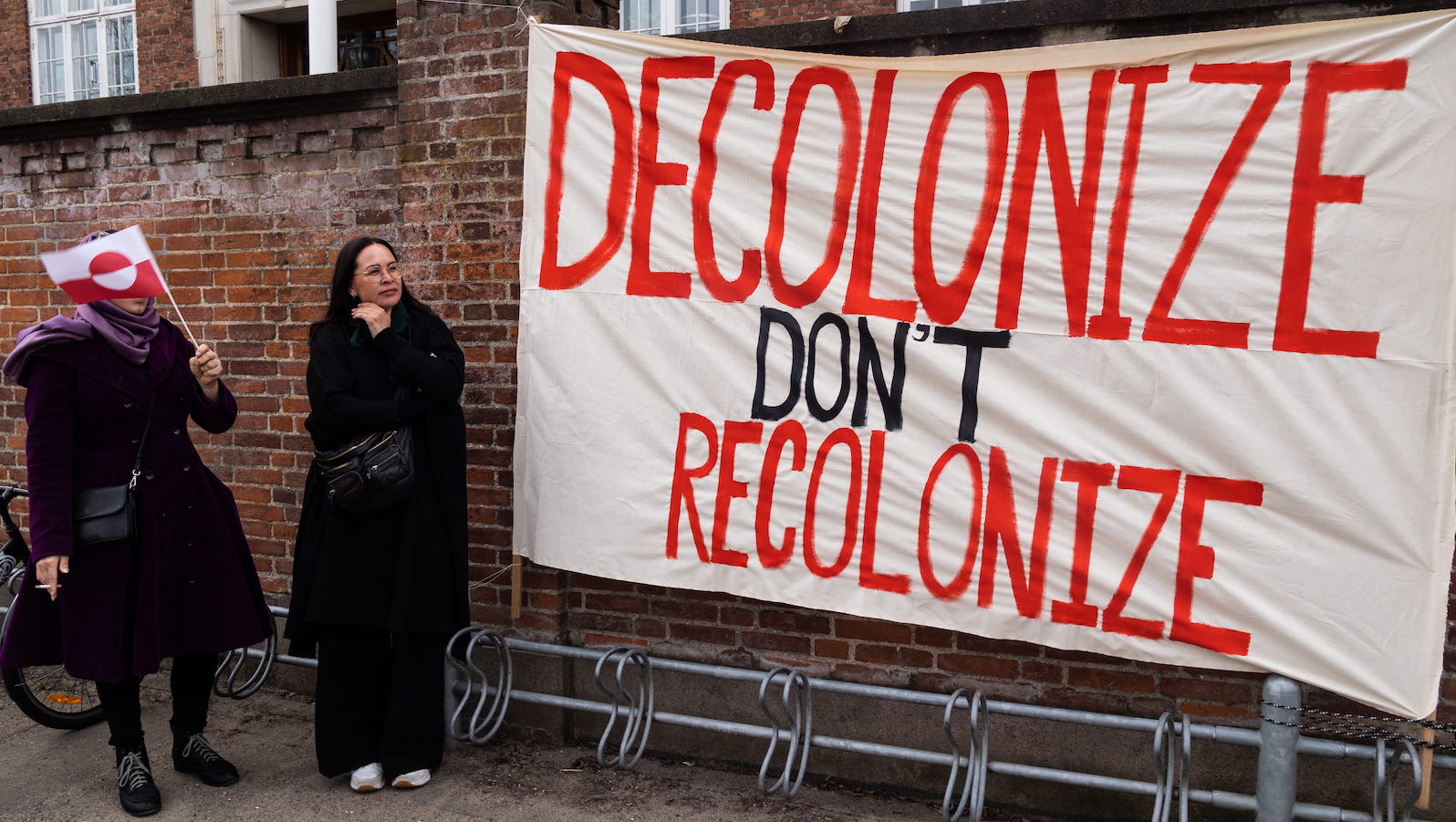 A banner that says "Decolonize Don't Recolonize" seen during a demonstration against the Trump administration in Copenhagen in 2025.