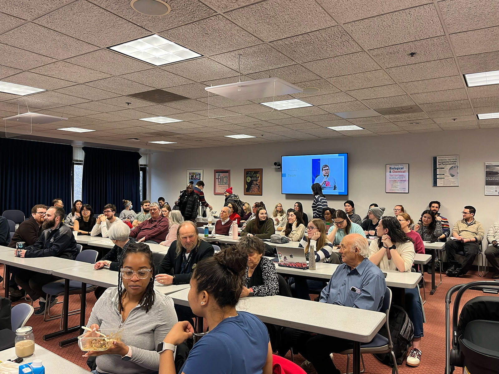 A room full of people sitting at desks