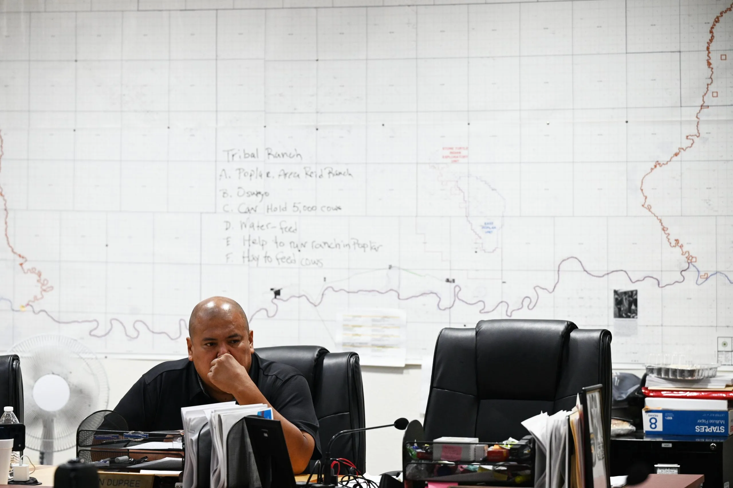 Jestin Dupree sitting at a desk with a map on the wall behind him