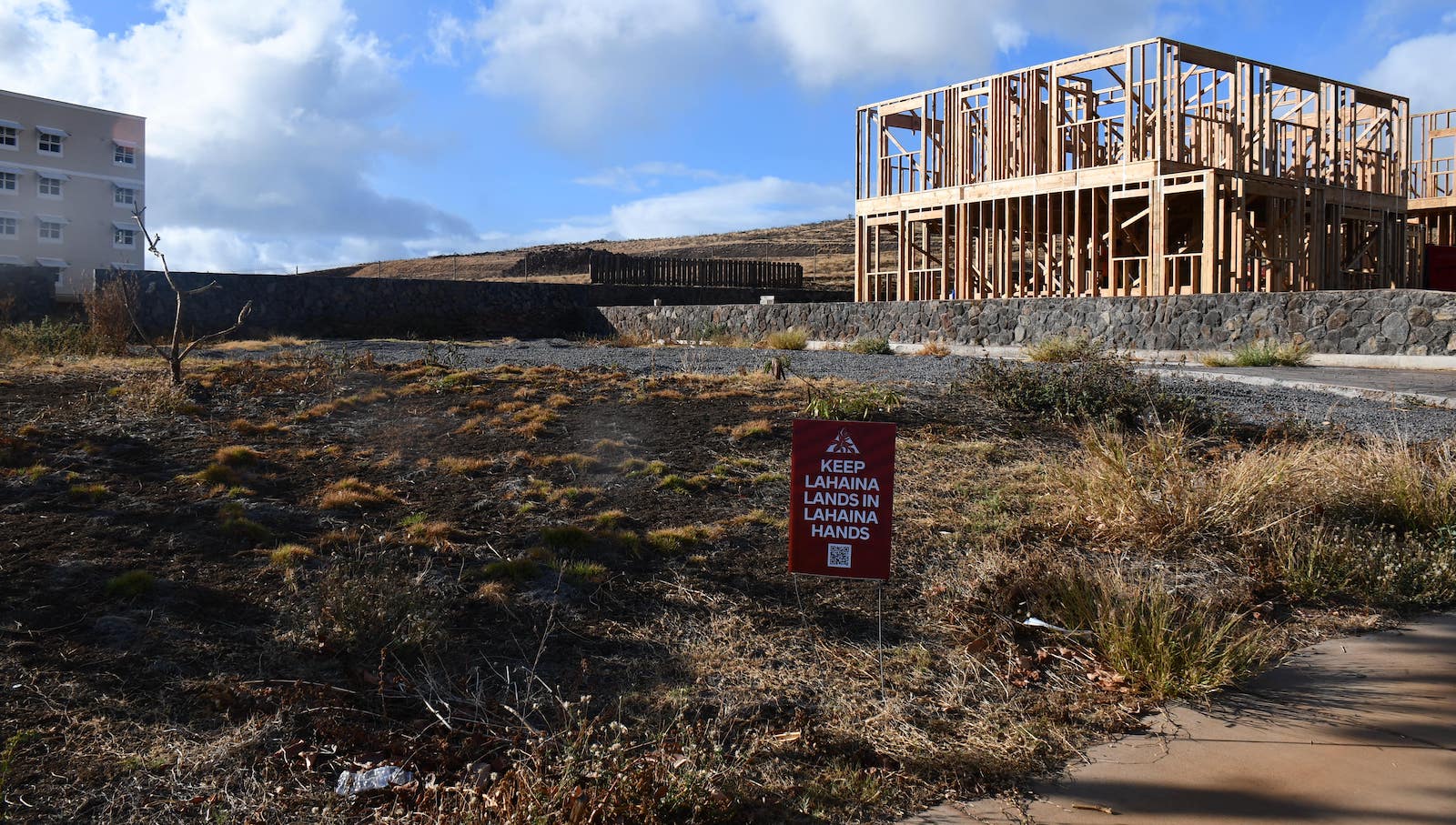 An empty lot with a sign 