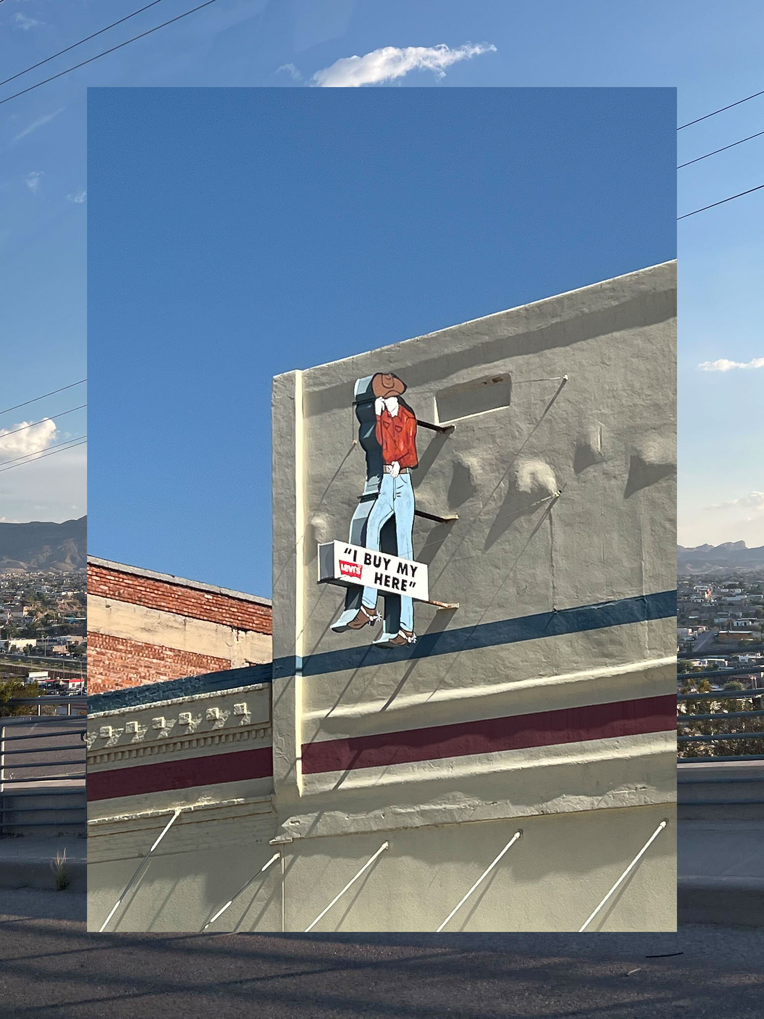 A collage consisting of two vertical photos, the outside functioning a border and the inside fully visible. The outside photo is a sunny view of El Paso. The inner photo is of a storefront sign that says 'I buy my Levis here' with an image of a cowboy.